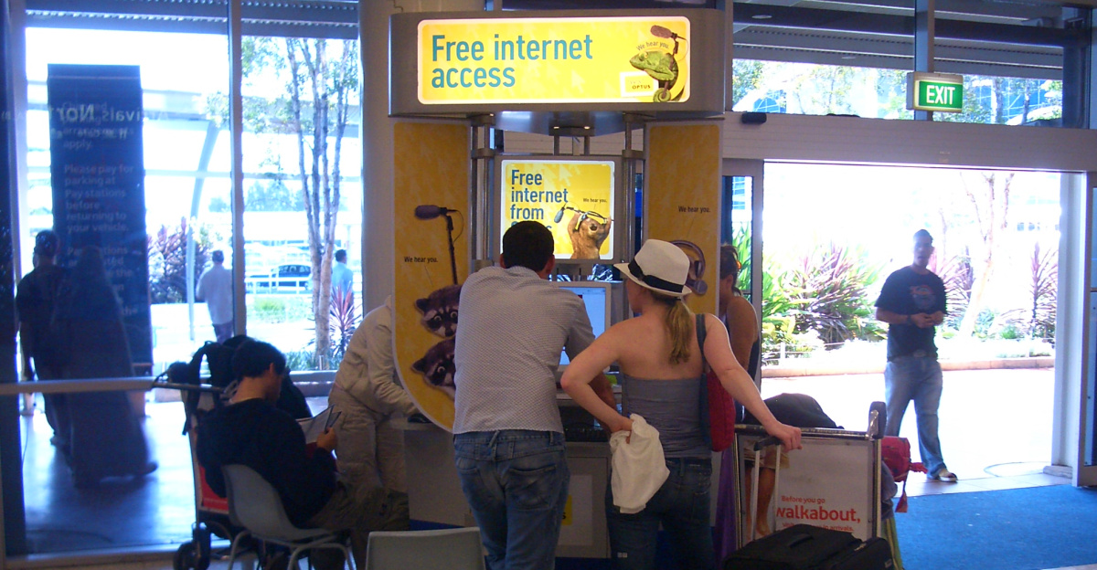 Passengers lining up at the three free Optus internet terminals at Sydney Airport, International Terminal