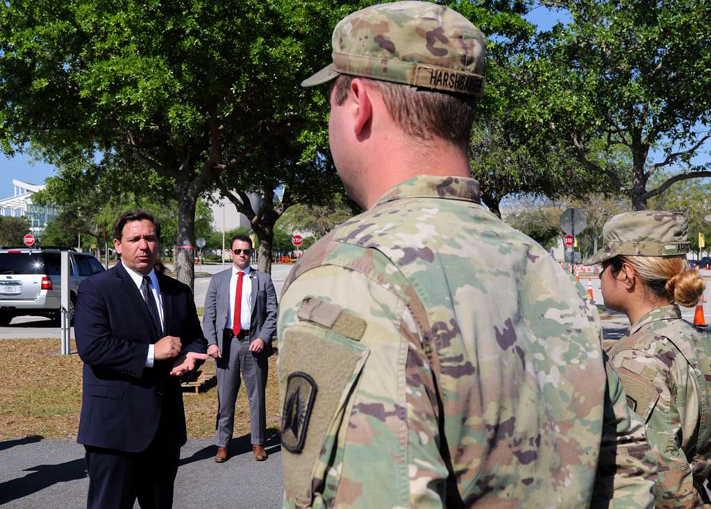 Florida Governor Ron DeSants meeting with soldiers during the opening of a COVID-19 testing site at Orange County Convention Center