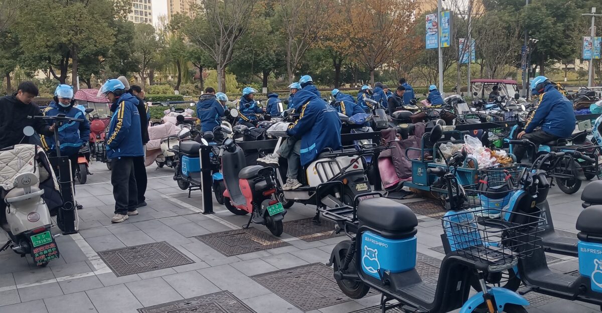 Freshippo delivery workers in square