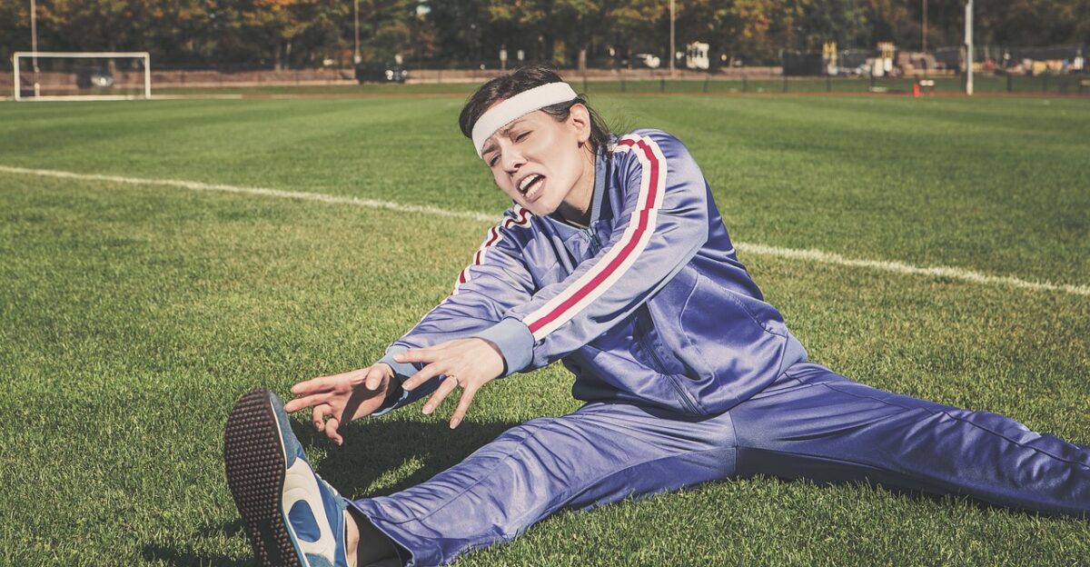 stretching sports woman athlete fitness sport healthy exercise workout young female body lifestyle training fit nature health stretch people active girl adult person sportswear athletic gym exercising physical sporty white pilates leisure tracksuit track and field shoes headband grass field