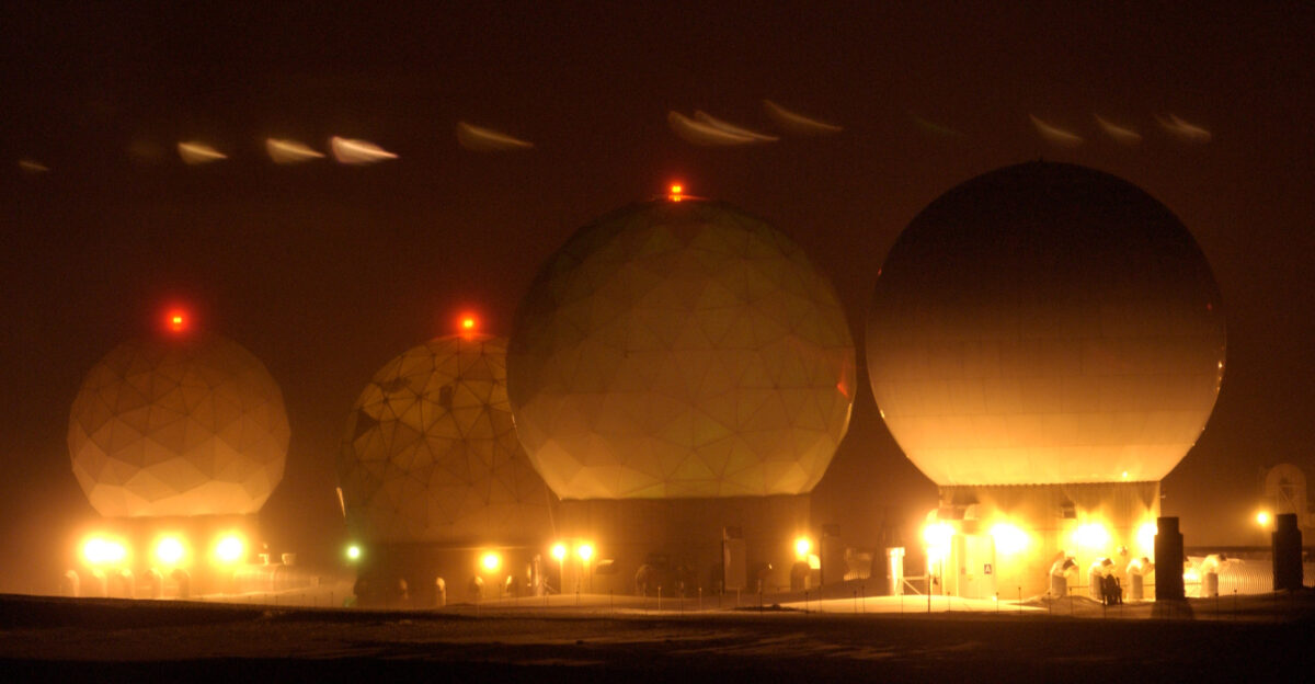 Four golf ball protective covers at Thule Air Base Greenland that house satellite dishes glow during the darkness Jan 25 Thule AB Airmen use the satellite dishes to communicate with orbiting satellites