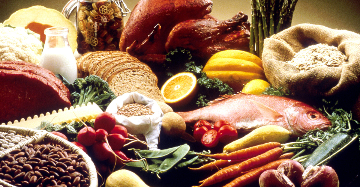 This image shows a display of healthy foods on a table Foods include beans grains cauliflower cantelope pasta bread orange turkey salmon carrots turnips zucchini snowpeas string beans radishes asparagus summer squash lean beef tomatoes and potatoes AV Number AV-8812-3430 Reuse Restrictions None - This image is in the public domain and can be freely reused Please credit the source and or author listed above