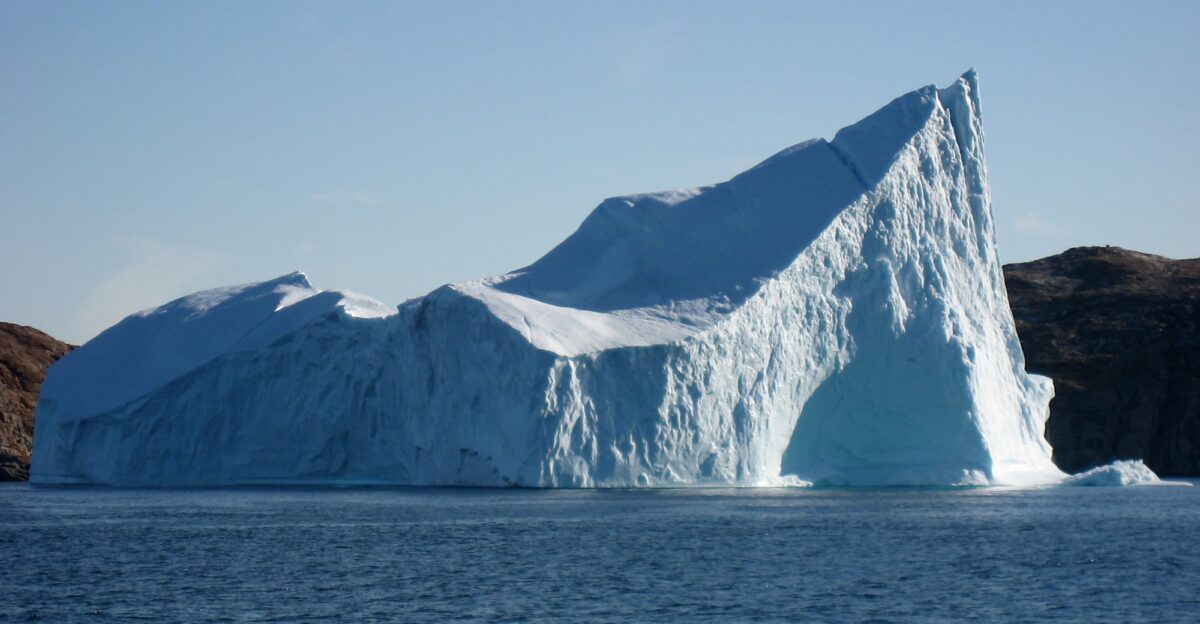 Iceberg with a hole in the strait between Lang and Sanderson Hope south of Upernavik Greenland