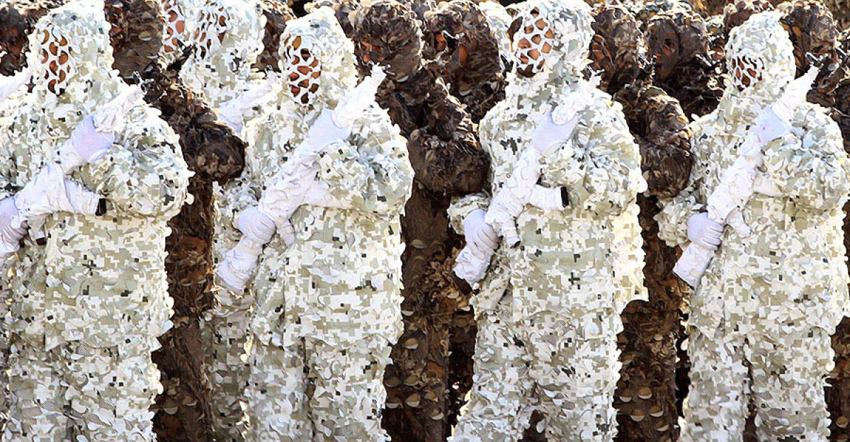 Iranian army land force soldiers in full camouflage suits march during Islamic Republic of Iran army day parade