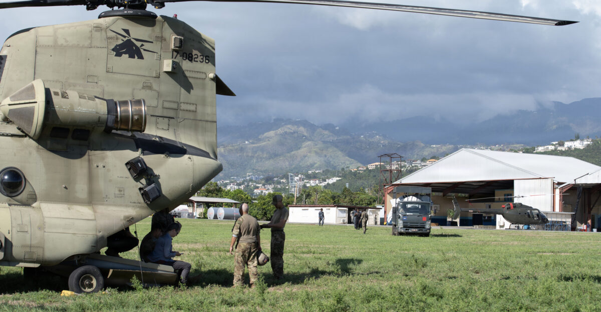 U S Servicemembers assigned to Joint Task Force-Bravo and representatives from the U S Department of State and the Los Angeles Fire Department Team wait to unload a truck bed of food onto a U S Army CH-47 Chinook at Up Park Camp Kingston Jamaica Nov 7 2025 U S military forces are deployed to Jamaica at the direction of the U S Southern Command to provide immediate lifesaving assistance following Hurricane Melissa U S Air Force Photo by Staff Sgt Merchak