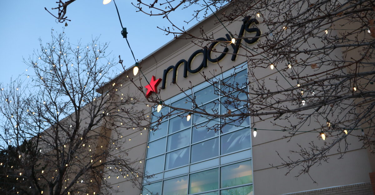 The facade of a Macy s department store on the night of it s announced closure