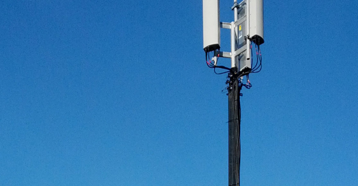 Verizon mobile cellular radio site trailer with antenna mast deployed and electrical generator trailer (to the left) for temporary augmented cell phone coverage.