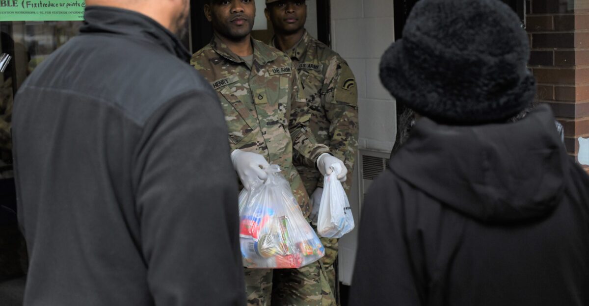 New York Army National Guard Soldiers distribute food to local residents in New Rochelle N Y on March 13 2020 as part of New York s efforts to contain the spread of the coronavirus known as COVID-19 in the area New York National Guard Soldiers were providing food to residents who could not get to the local store because of closures in the area U S Air National Guard Photo by Major Patrick Cordova