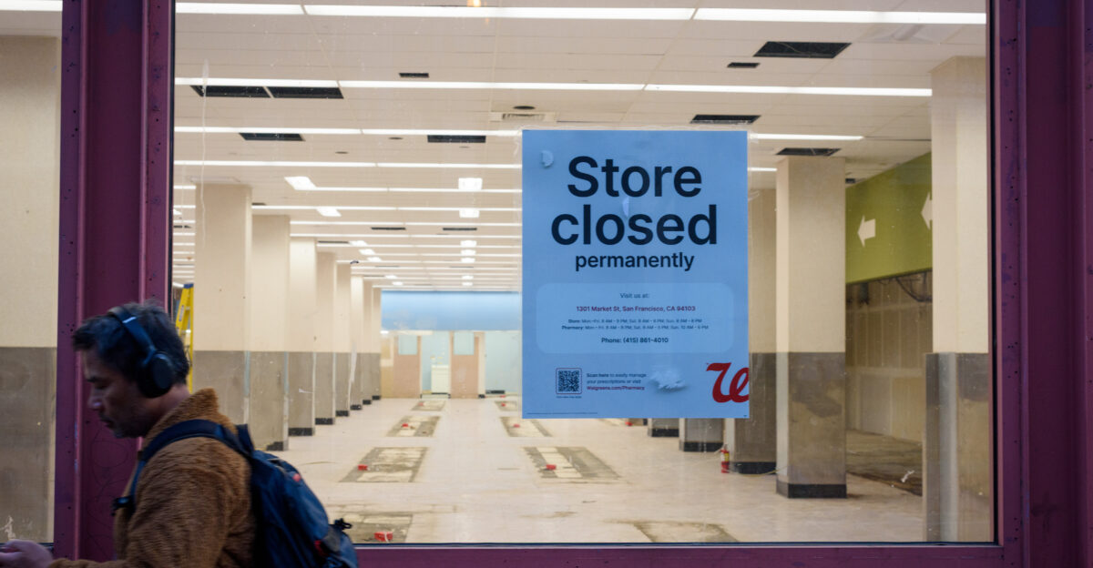 A person walks past a permanently closed Walgreens on Market St in downtown San Francisco