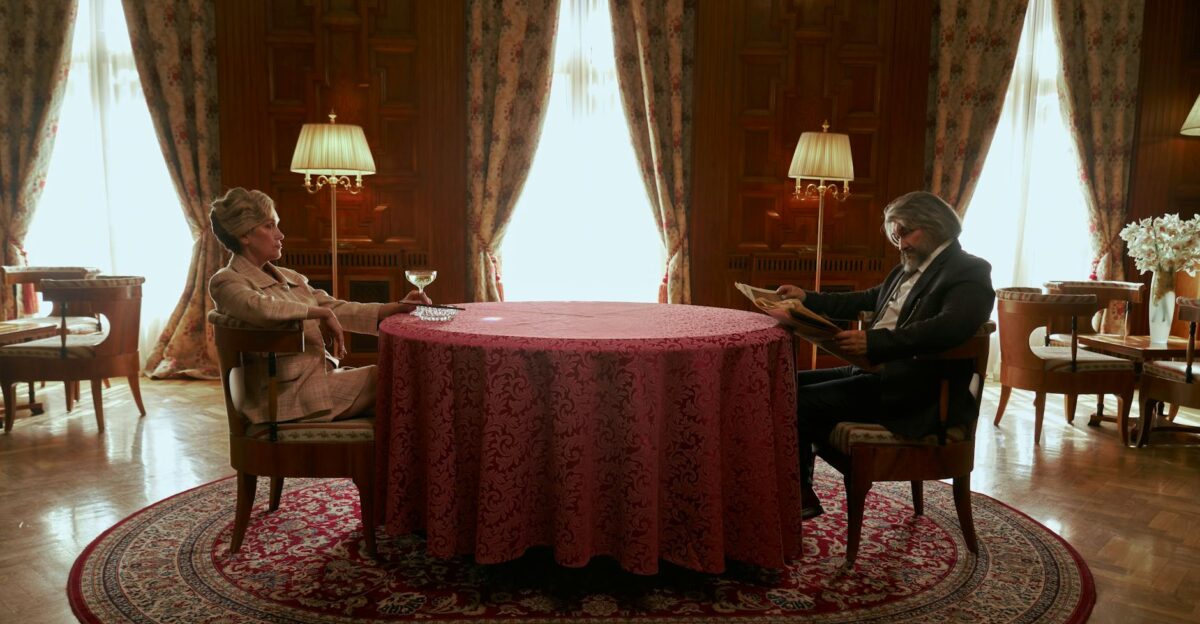 An elegant senior couple in a luxurious vintage room with rich decor and ambient lighting