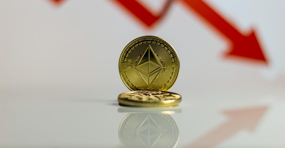 Close-up of Ethereum cryptocurrency with red downward arrow symbolizing market decline
