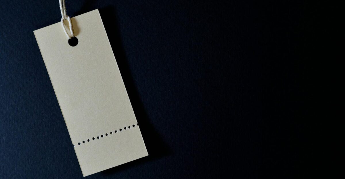 Elegant minimalist card with a string ideal for labeling or pricing against a black background
