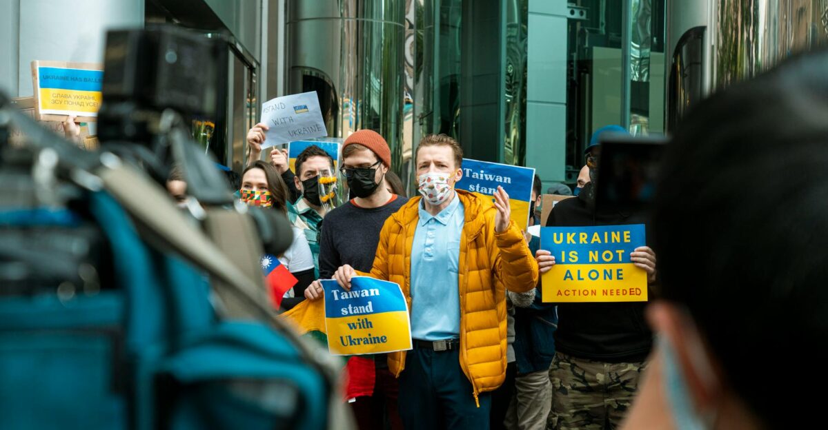 Group of protesters holding signs supporting Taiwan and Ukraine in a peaceful demonstration