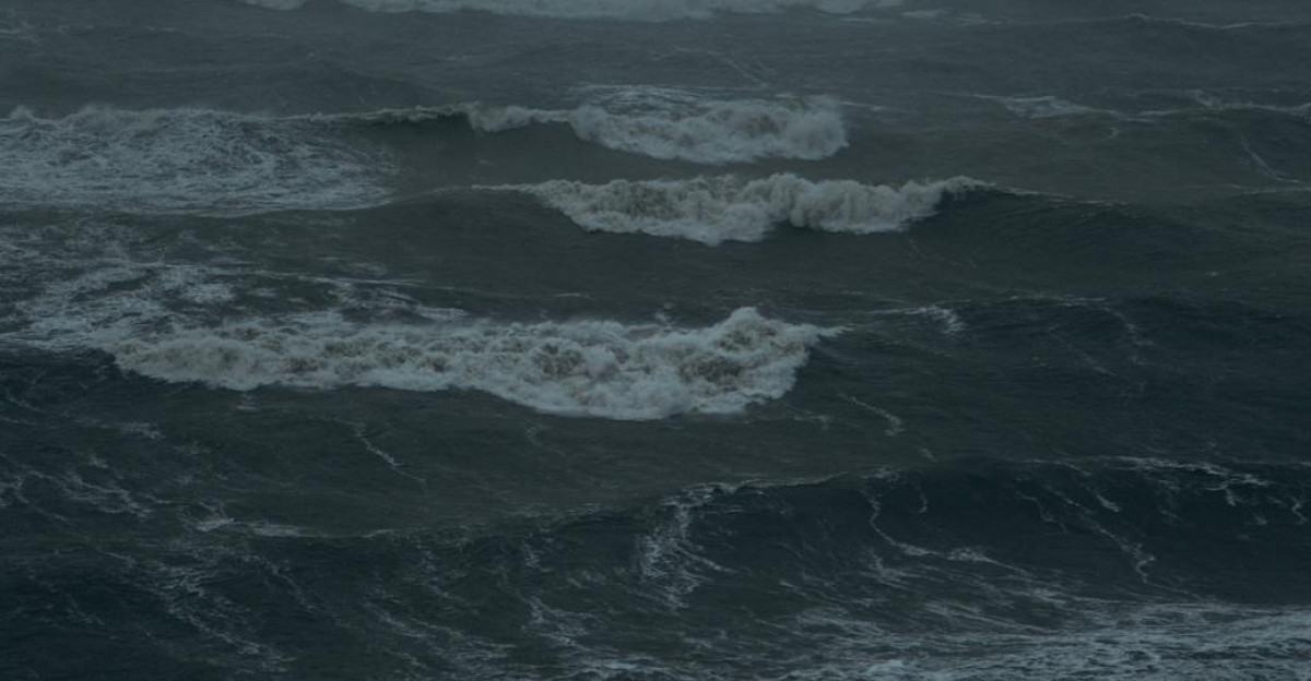 Dark and moody image of ocean waves with fog capturing the essence of a stormy sea