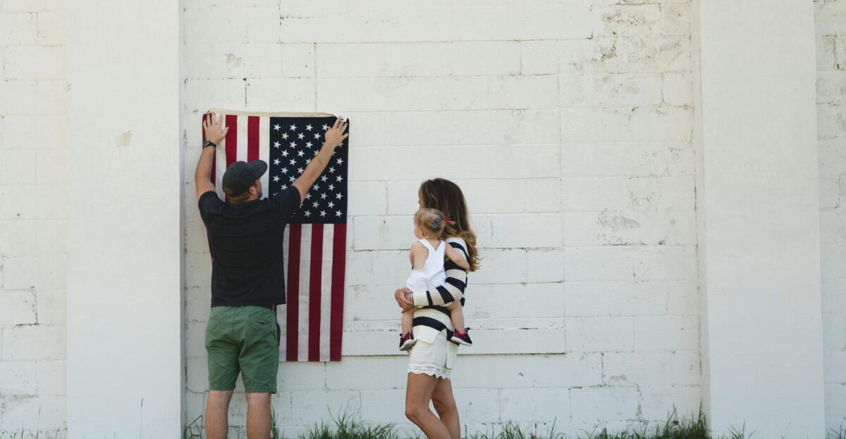 Family celebrating with American flag outdoors symbolizing patriotism and togetherness
