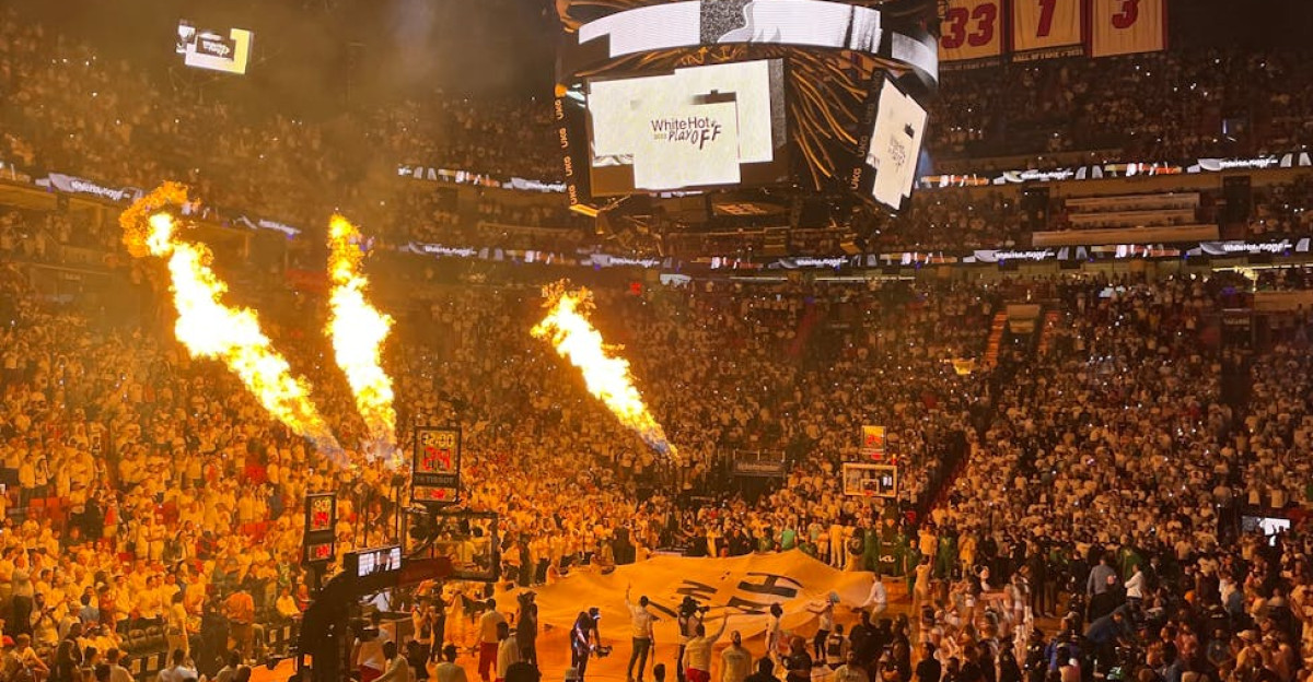 High-energy Miami Heat basketball game with a packed stadium and fiery pre-game show