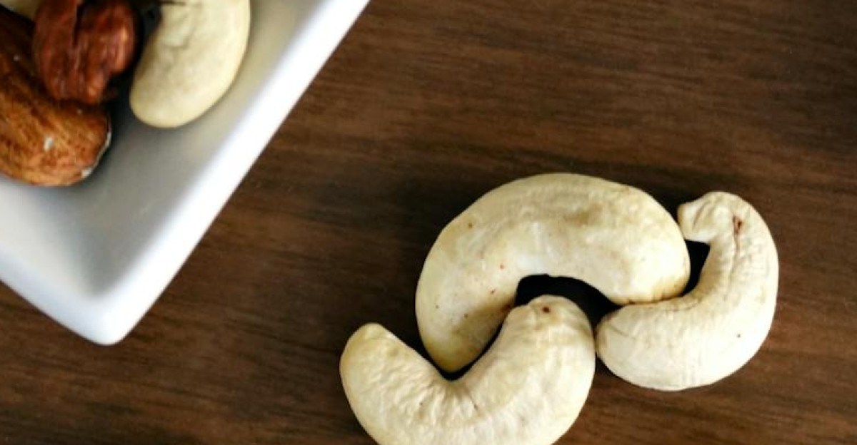 Close-up of various nuts on a wooden table showcasing healthy snacking options