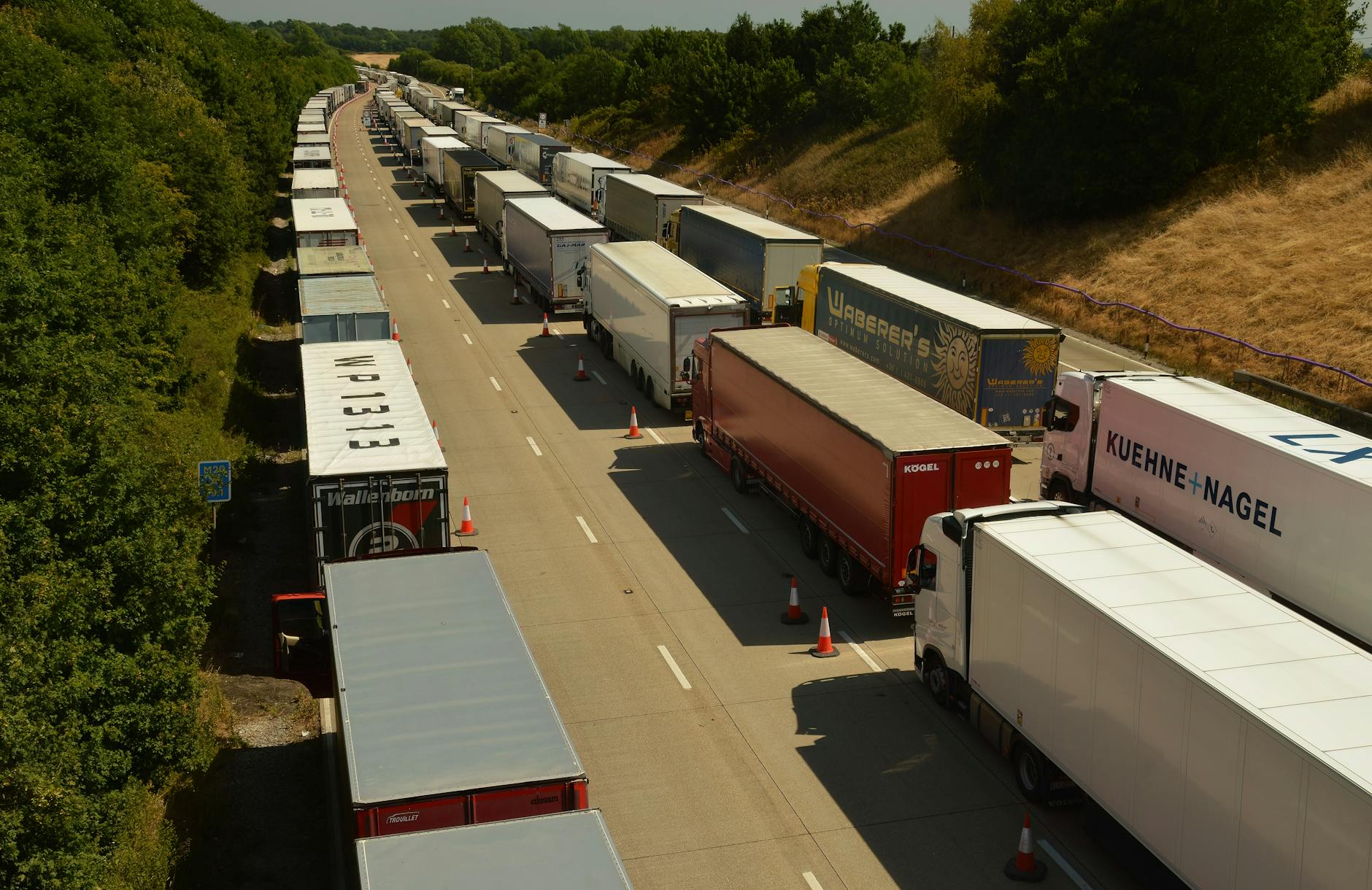 Drone shot capturing traffic jam of trailer trucks on a highway in England