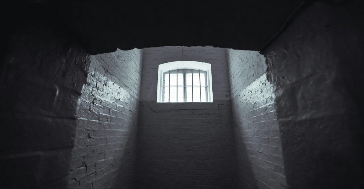 Moody shot of an abandoned prison cell in Hong Kong with dim lighting and shadowy walls