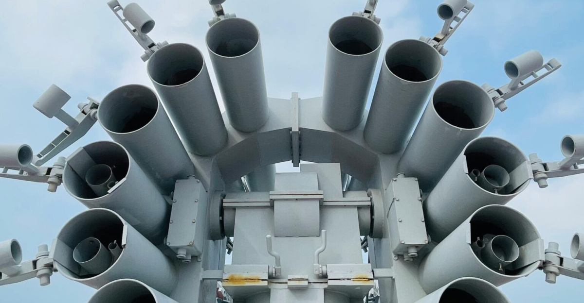 Close-up of naval artillery on a warship at Tianjin Harbour, China, showcasing military might.