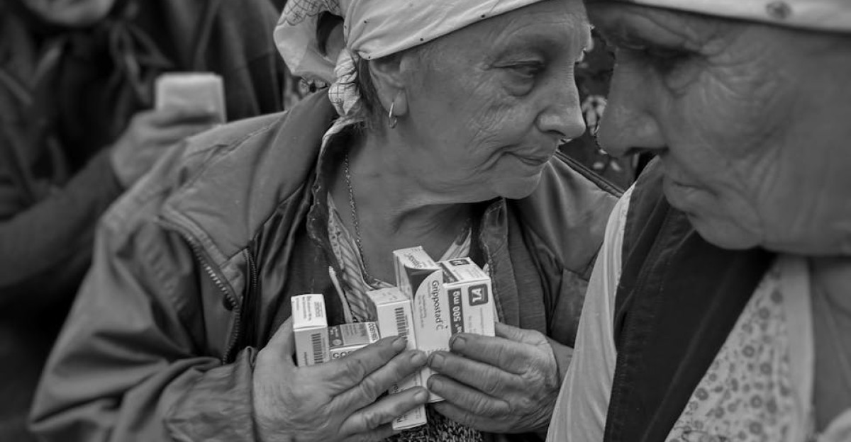 Elderly women receiving medical aid in Ukraine highlighting humanitarian efforts