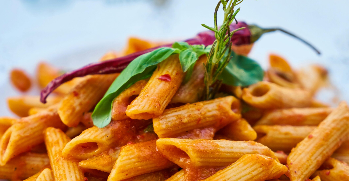 Savor the flavors of Italian cuisine with this close-up photo of tasty penne pasta in tomato sauce.