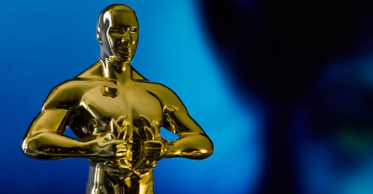 A shining Oscar statuette, symbolizing achievement in the film industry, against a vibrant blue backdrop.