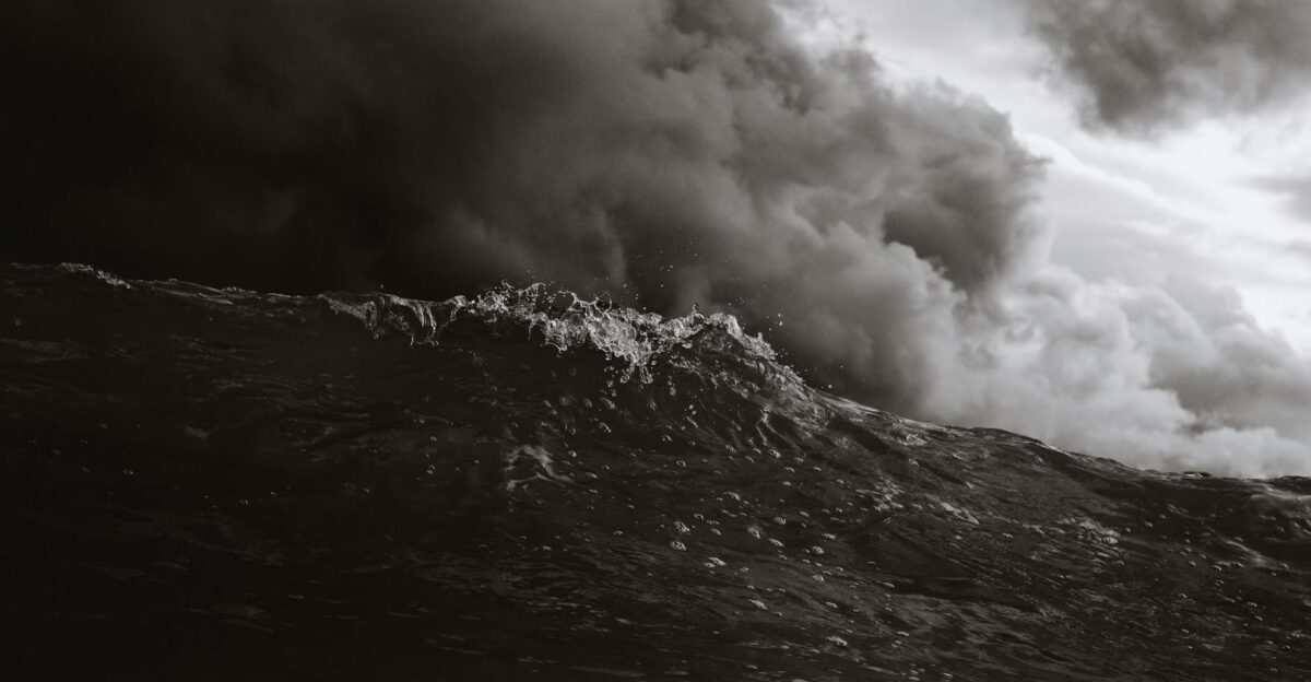 Powerful ocean wave with storm clouds in monochrome capturing nature s intensity