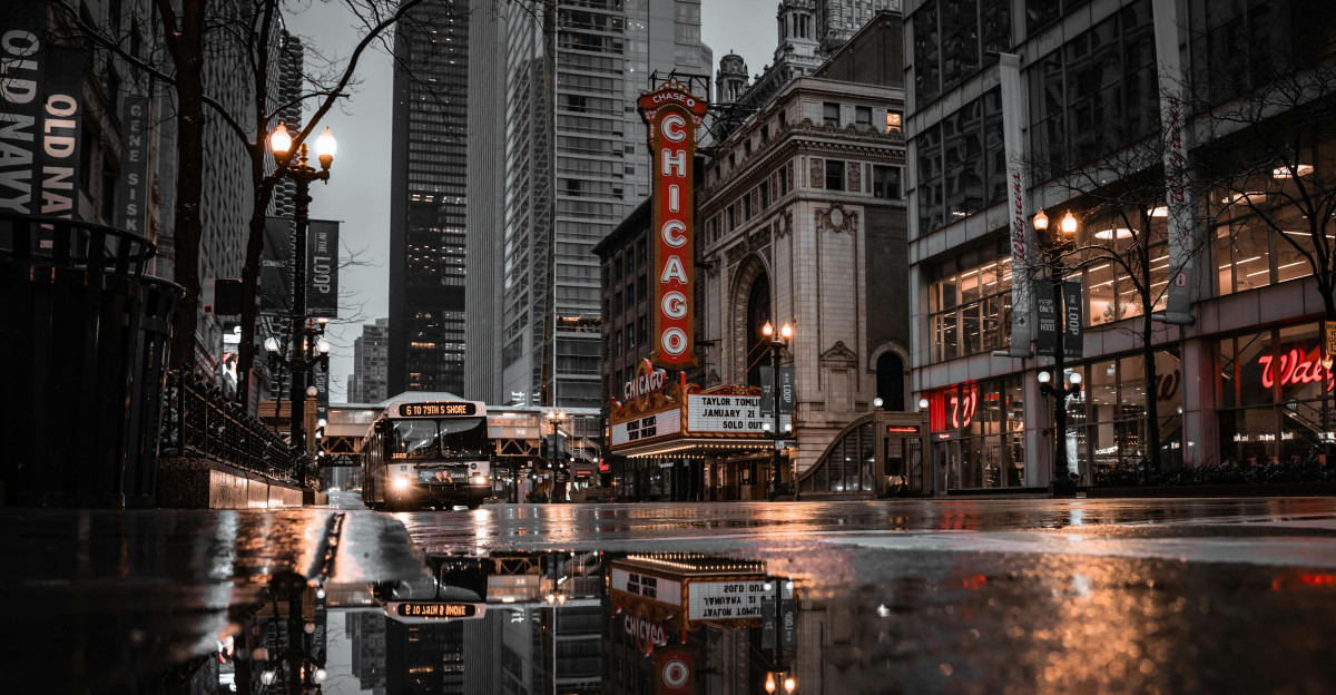 Buildings Reflection in Puddle near Chicago Theatre Free Stock Photo