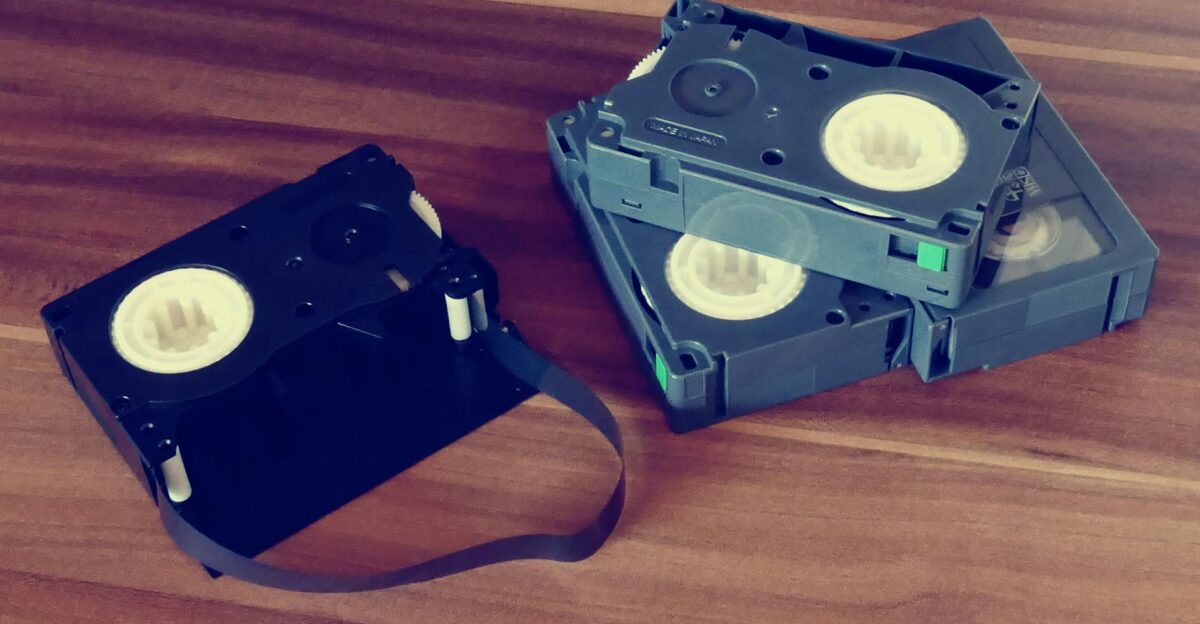 Close-up of retro video cassettes on a wooden table Obsolete technology