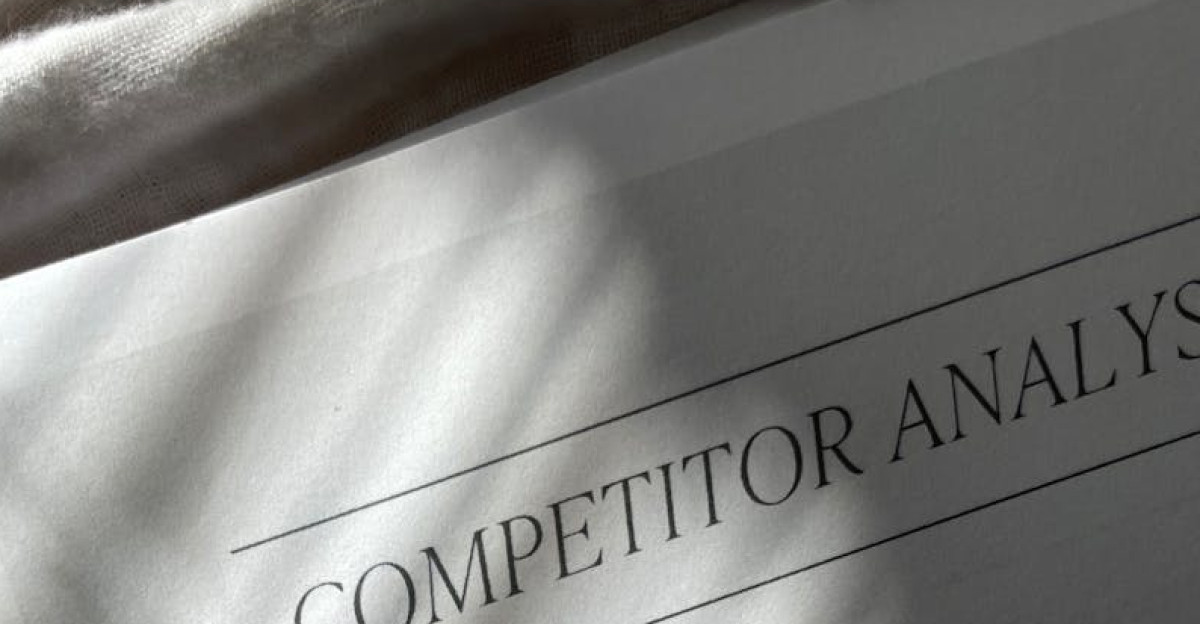 A competitor analysis sheet with stylish shadows on a textured fabric background conveying a professional tone