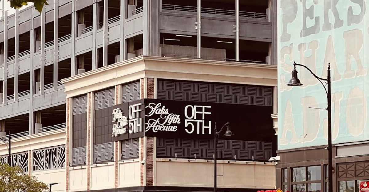 Street view of a modern building with prominent store signage on a busy urban street