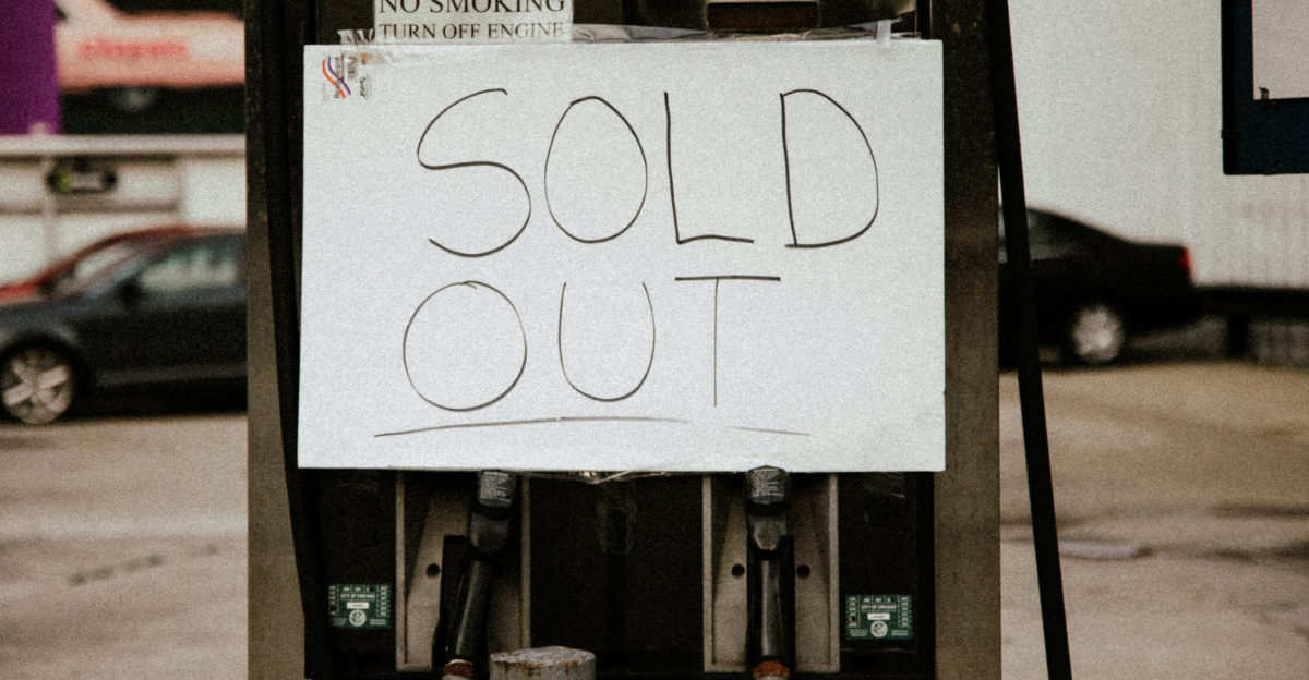 A gas pump at an urban station displaying a 'Sold Out' sign, illustrating fuel shortage.