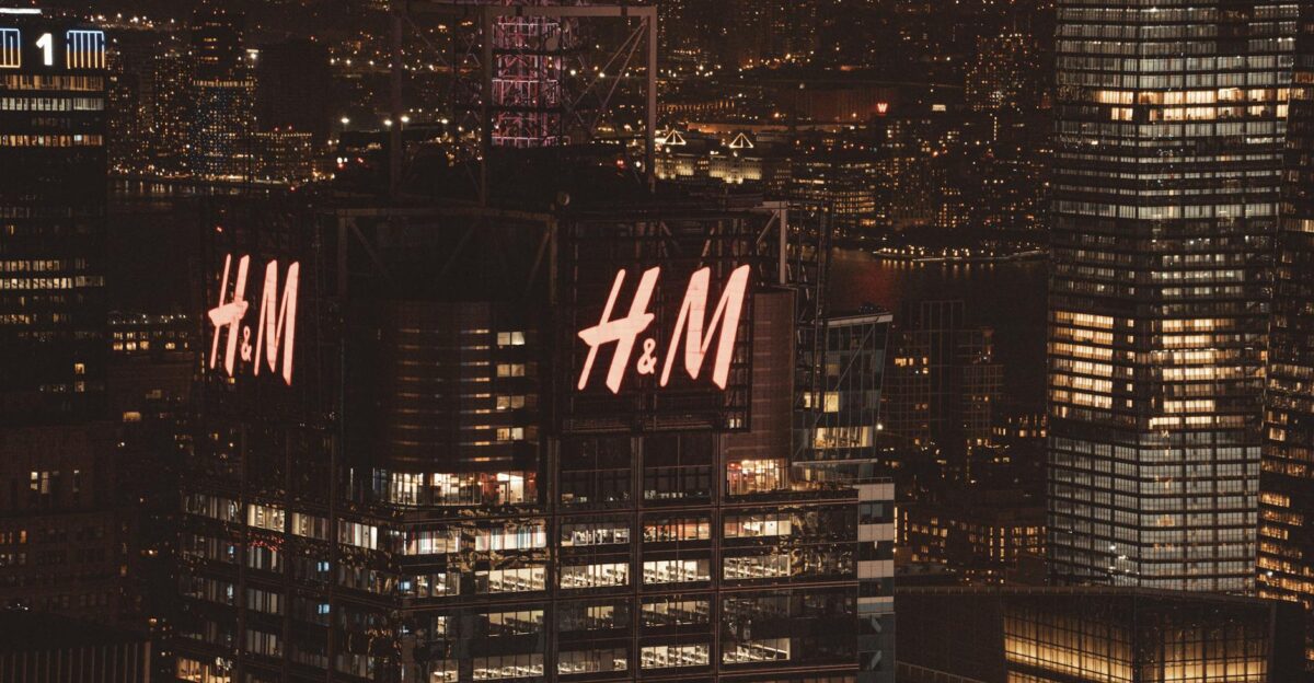 High-angle view of illuminated skyscrapers in New York City at night featuring H M building lights