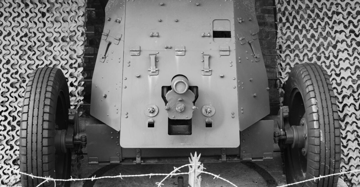 Front view of a World War II anti-tank cannon at a museum in black and white
