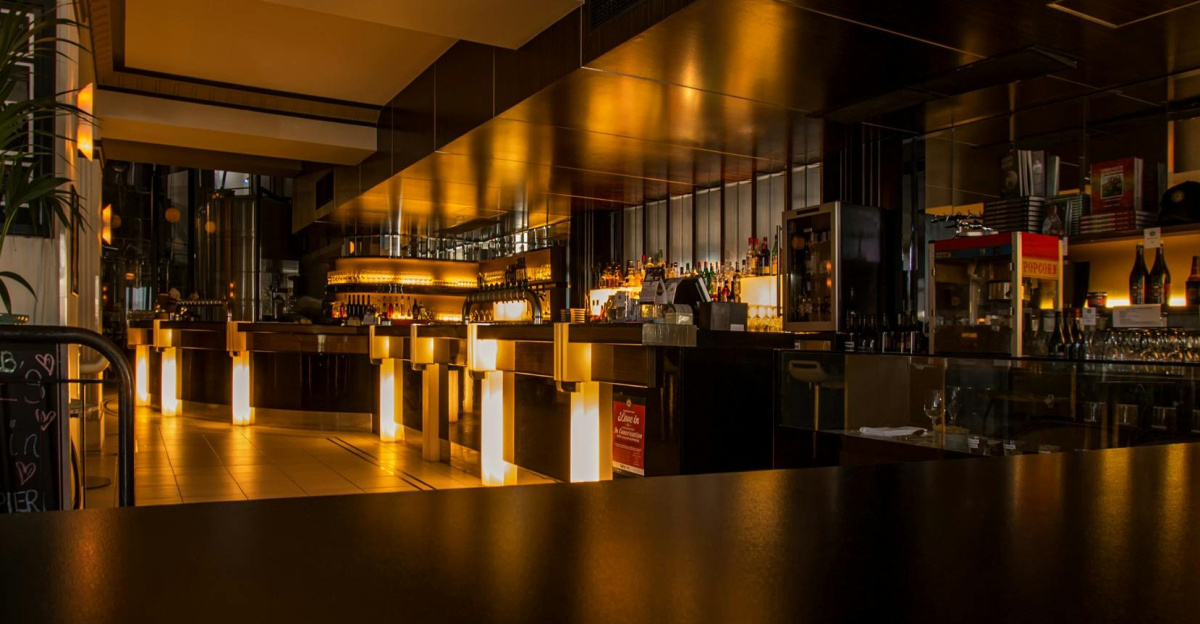 Stylish modern restaurant interior with warm lighting, elegant design, and luxurious ambiance at night.