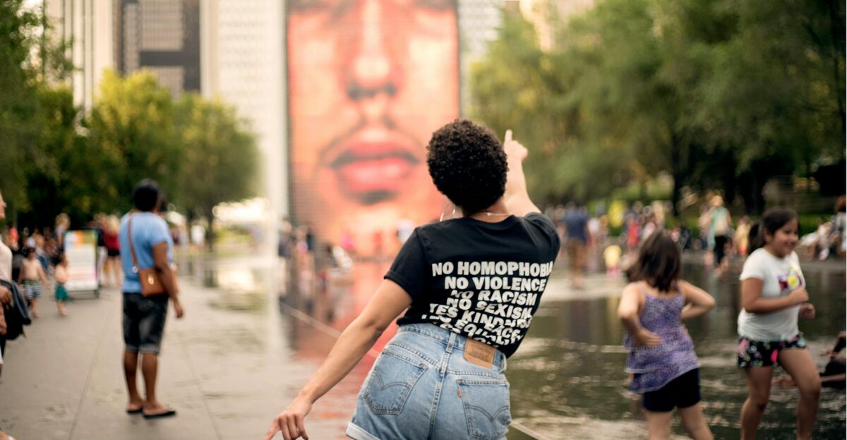 People enjoying a vibrant summer day in Chicago celebrating diversity and inclusion at a popular landmark