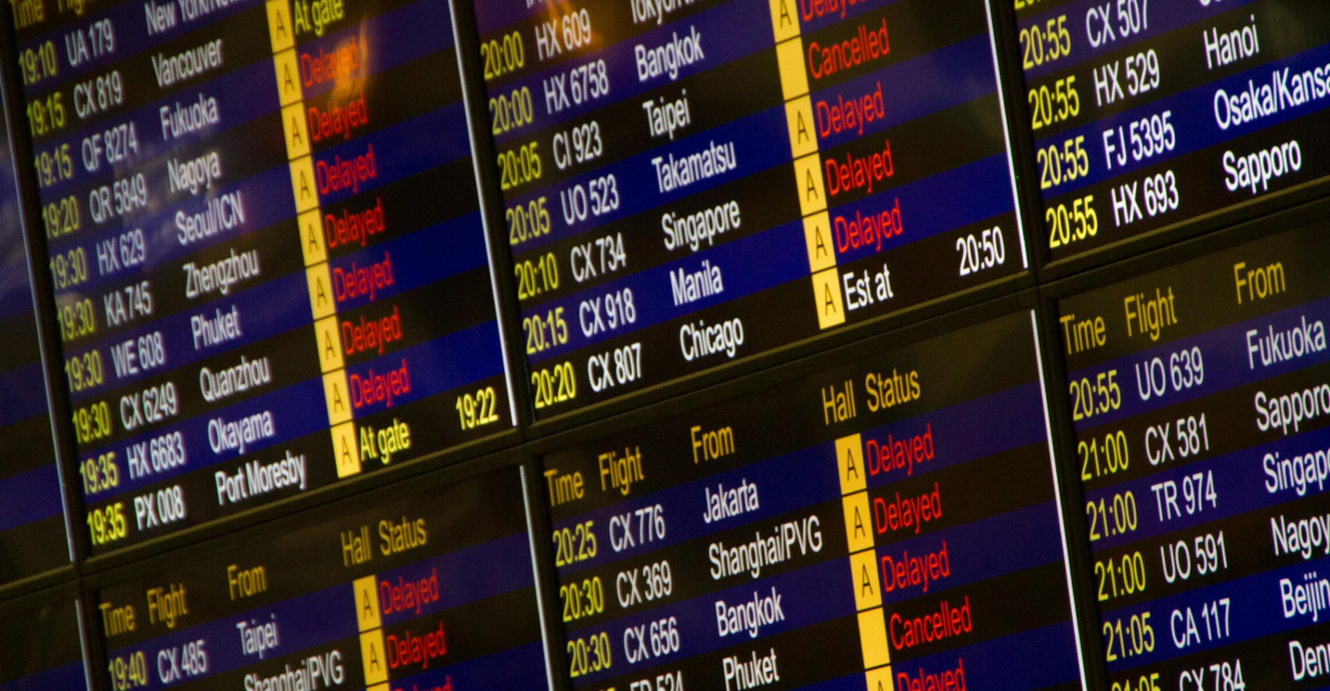 Close-up of digital flight information board showing arrivals and departures at an airport.