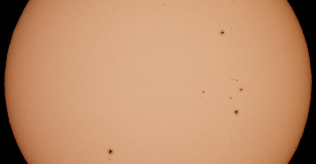 Close-up image of the sun showing visible sunspots captured with high detail