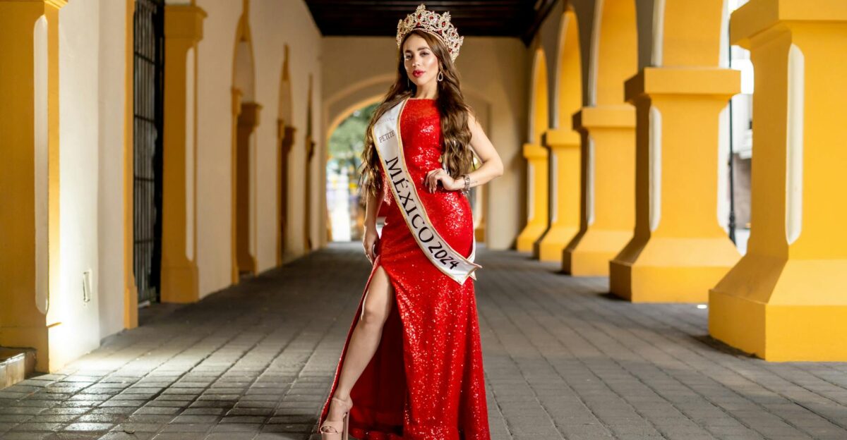 Miss Mexico 2024 contestant in a red gown standing in a historic Monterrey archway