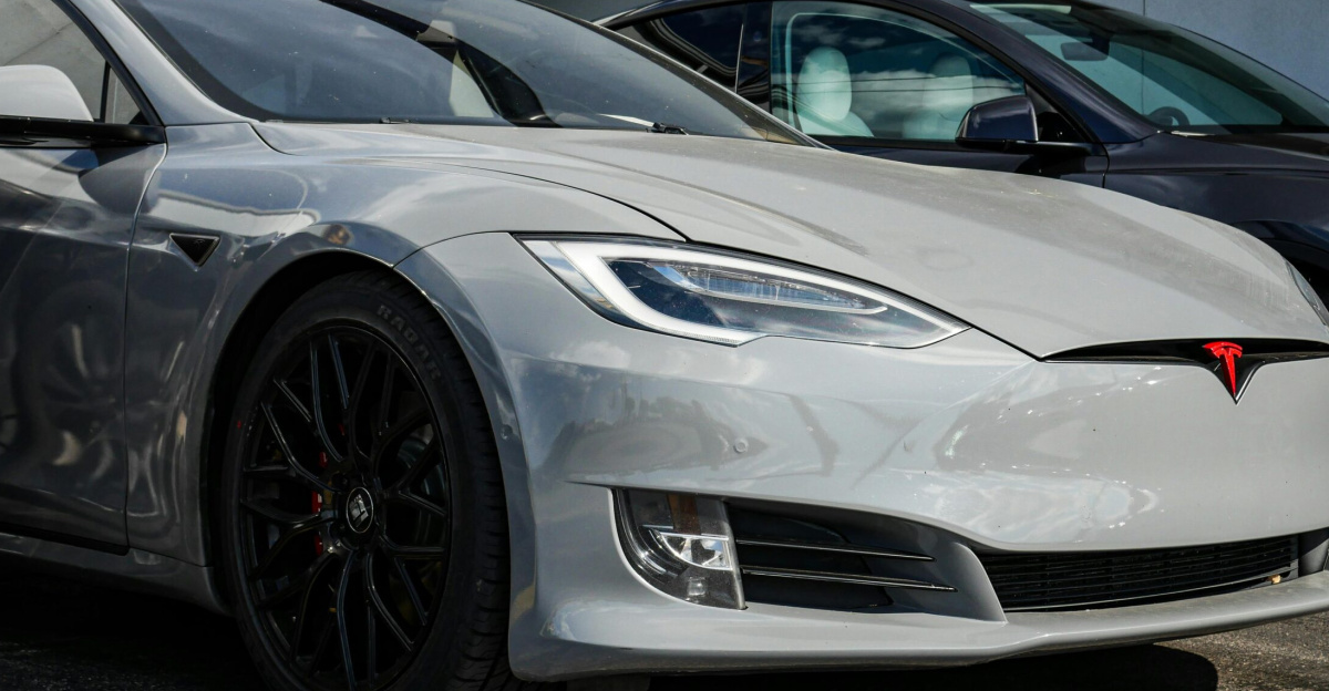 Close-up view of a sleek Tesla Model S parked outdoors, showcasing modern electric vehicle design.