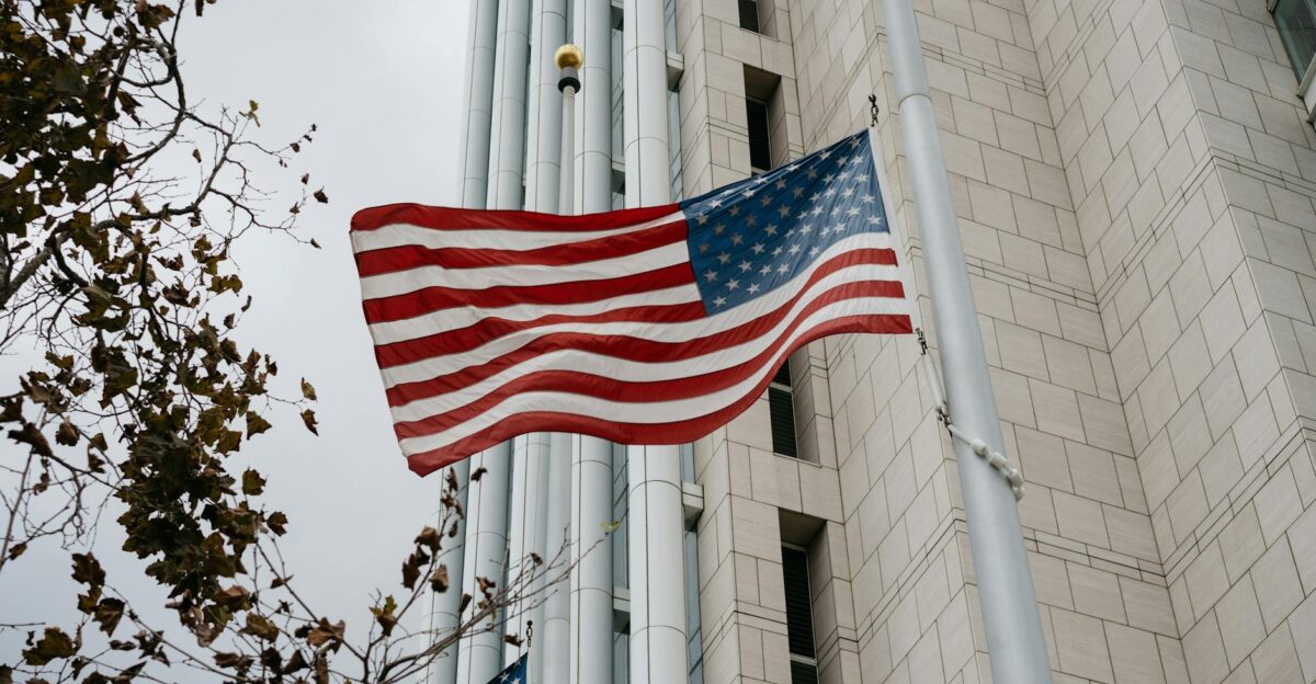 Low angle of American flag waving in front of a government building in Anaheim CA