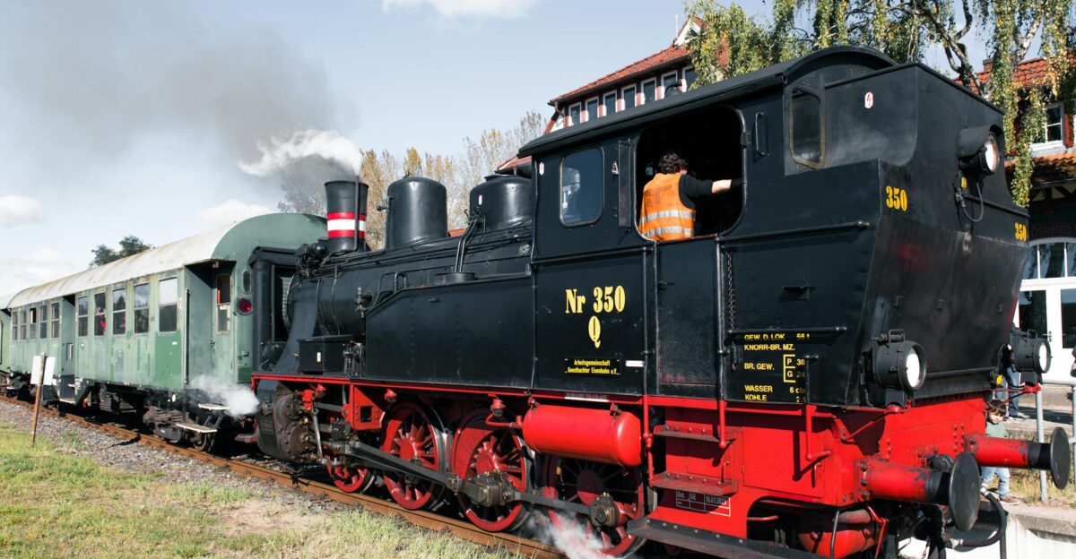 A classic steam train parked at a historic train station evoking nostalgia and travel adventure