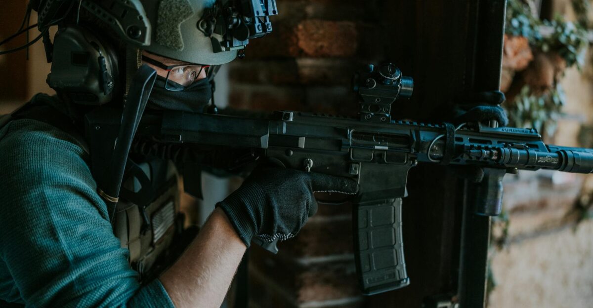 A special forces soldier equipped with tactical gear and weapon engaging in a mission indoors
