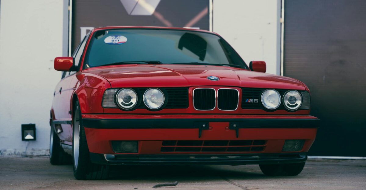 Front view of a vintage red BMW M5 E34 parked outdoors in Benghazi Libya