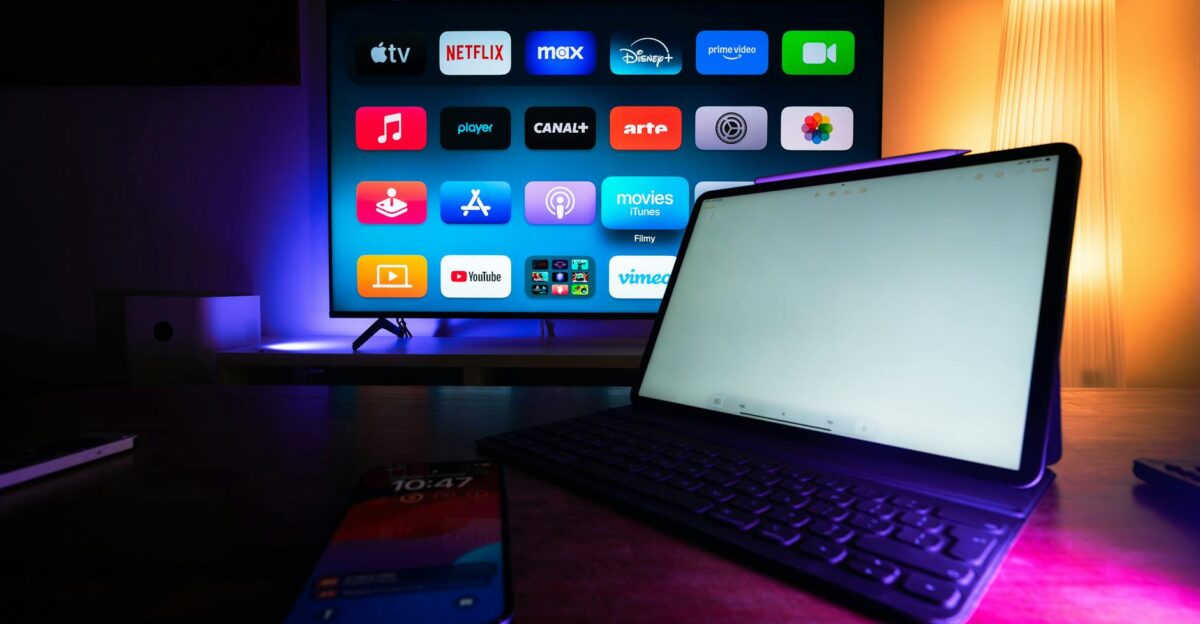 A modern home setup with a smart TV and tablet displaying various streaming apps highlighting the digital lifestyle