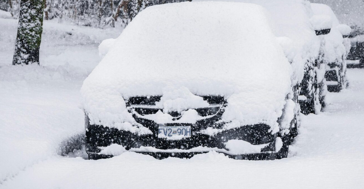 Parked cars covered in heavy snow during a blizzard in Vancouver, Canada.