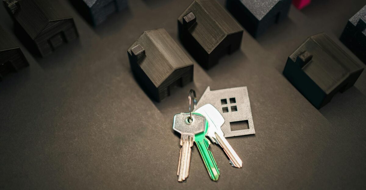 Miniature house models and keys symbolize real estate investment and housing market
