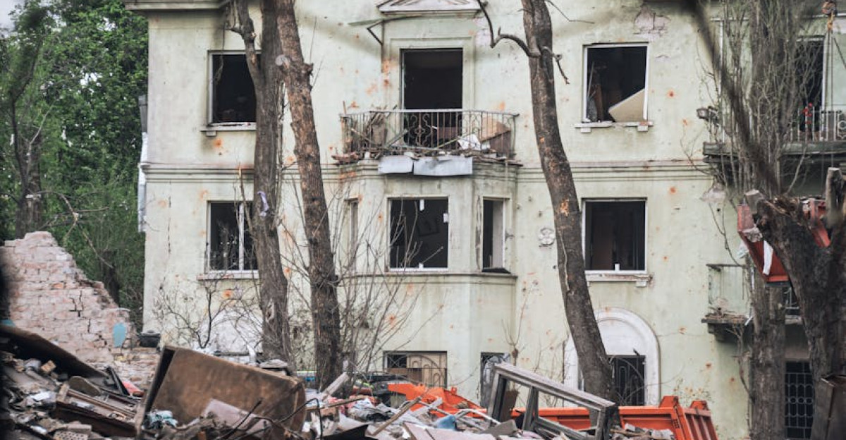 Rubble and a damaged building in Kyiv highlight war destruction s impact on urban landscape