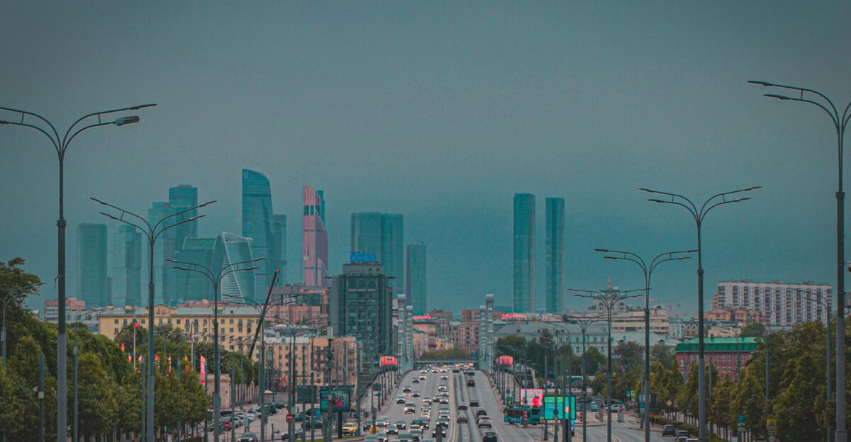 Dynamic view of Moscow City skyline with busy urban traffic and skyscrapers at dusk